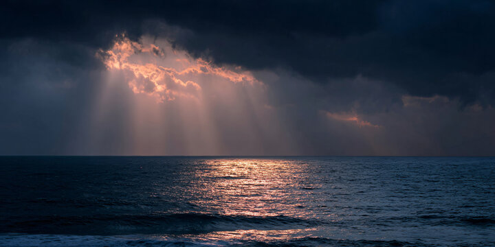 Sunlight Rays Through Storm Clouds Over Ocean