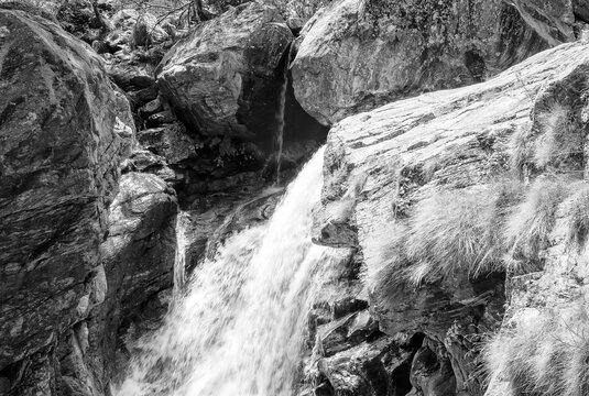 View of a waterfall, formed by the melting waters of the surrounding glaciers, which dives into Antrona Lake (Italian Alps, Piedmont, Near the Swiss border).