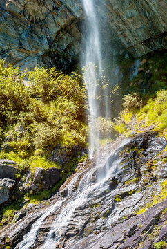 View of Sajont waterfall, formed by the melting waters of the surrounding glaciers, which dives into Antrona Lake (Italian Alps, Piedmont, Near the Swiss border).