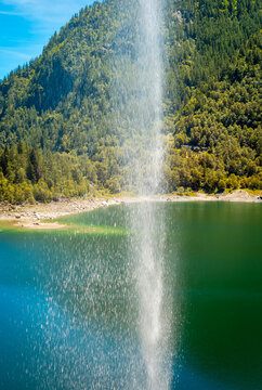 View of Sajont waterfall, formed by the melting waters of the surrounding glaciers, which dives into Antrona Lake (Italian Alps, Piedmont, Near the Swiss border).