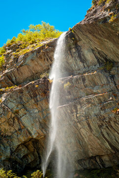 View of Sajont waterfall, formed by the melting waters of the surrounding glaciers, which dives into Antrona Lake (Italian Alps, Piedmont, Near the Swiss border).