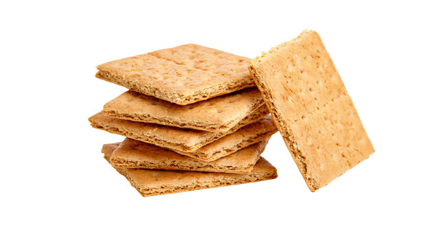 Stack of golden brown graham crackers with one standing upright