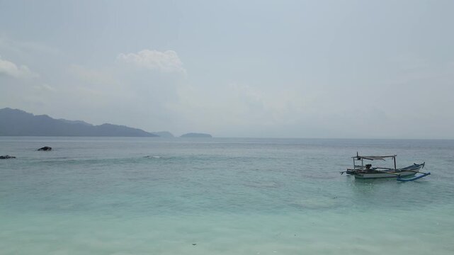 Aerial Of Traditional Outrigger Boat In Clear Shallows Lampung