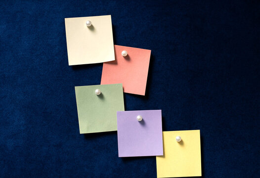 Colorful sticky notes arranged in ascending steps on dark background minimalist composition