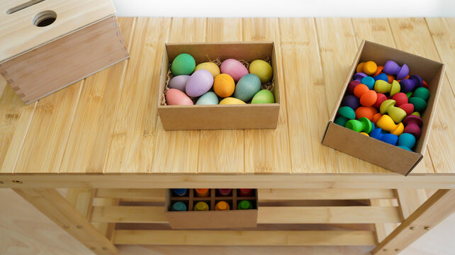 Montessori educational toys and colorful wooden eggs on table