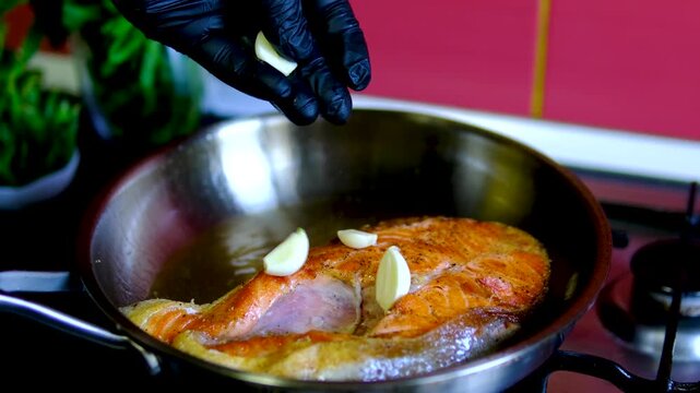 Step by step salmon recipe asparagus garlic butter cooked on stainless steel skillet in modern kitchen healthy gourmet meal preparation salmon recipe, healthy, cooking process, restaurant style meal