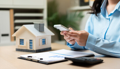Home insurance and property management concept with smartphone technology, real estate investment planning, housing finance, mortgage services, digital property management, and homeowner solutions. © Father_Studio