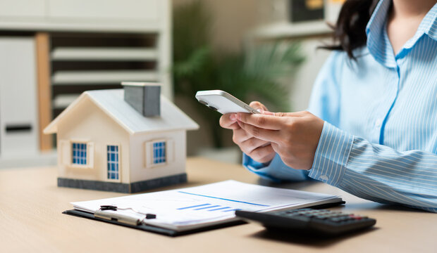 Home insurance and property management concept with smartphone technology, real estate investment planning, housing finance, mortgage services, digital property management, and homeowner solutions.