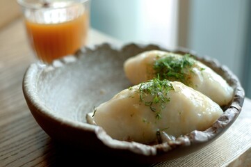 Lithuanian national dish - cepelinai or didzkukuliai with fried bacon and herbs © Irina