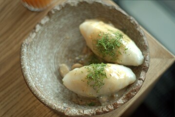 Lithuanian national dish - cepelinai or didzkukuliai with fried bacon and herbs © Irina