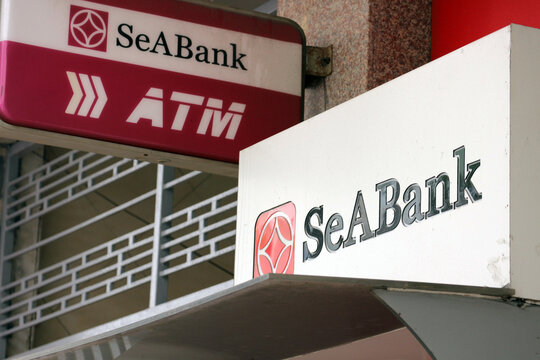 SeABank branded name signs above automated teller machine ATM station on the city street, Danang, Vietnam - January 23, 2026