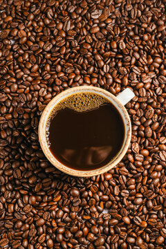 Roasted coffee beans and ground coffee in cups on white background, flat lay with copy space