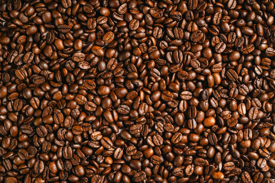 Roasted coffee beans background texture, top view full frame