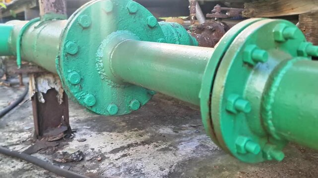 Industrial Green Steel Pipe Flange Connection with Bolted Joint at Outdoor Water Cooling Plant