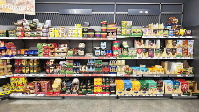 Iserlohn, Germany - May 22, 2026: A supermarket aisle displaying various coffee, muesli, and breakfast products on multiple shelves with price tags inside PENNY supermarket