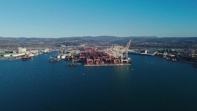 Koper, Slovenia offers a view of the Adriatic Sea with its marina and buildings as the sun sets over this coastal city.