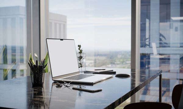 Modern office desk with laptop mockup and city view through windows