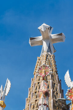 Barcelona, Spain. June 13, 2026, Sagrada Familia central Jesus Christ tower with prominent four pointed cross against vivid clear blue sky, iconic Gaudi landmark