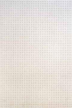 Clean white pegboard background texture with a grid pattern of small round holes. Minimalist wall panel for storage organization or tool display. Abstract backdrop for design and workshop concepts.