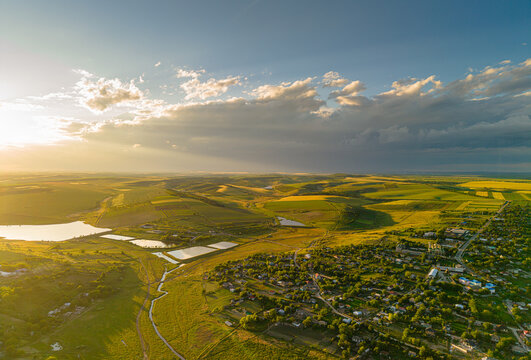 Beautiful moldovan rural landscape at sunset, scenic drone view of rolling hills and traditional village countryside