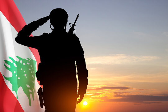 Silhouette of a soldier with Lebanon flag against the sunset. National Holidays concept. Armed Force of Lebanon
