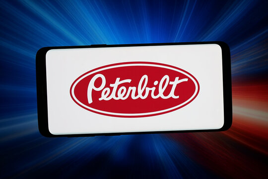 Stuttgart, Germany - 06-11-2026: In this photo illustration, the logo of truck manufacturer Peterbilt Motors Company is displayed on a smartphone in front of abstract background on computer screen.