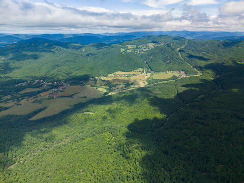 Aerial view of Bohunicky Rohac in Stiavnicke Vrchy with lush green forests and rolling hills under a cloudy sky in Bohunice, Nitra Region, Slovakia.