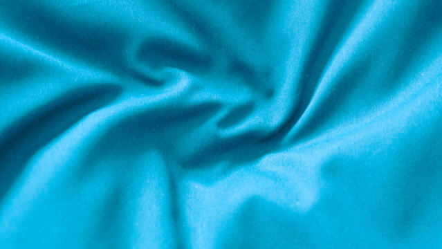 Blue fabric texture with soft waves close up