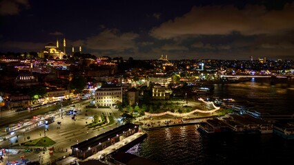 Fototapeta premium Istanbul, Turkey - June 13, 2026: Aerial drone night view of Istanbul, showing illuminated city streets, districts, historic neighborhoods, rooftops, city lights, and the urban skyline.