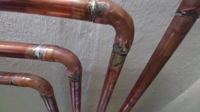 Detail of newly soldered copper pipes joints in a domestic heating installation