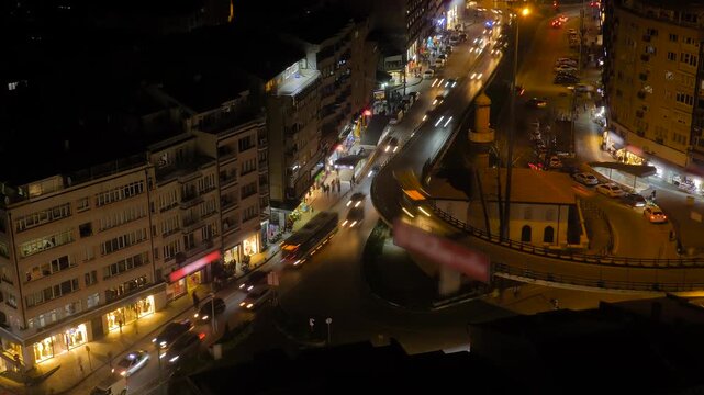 Time lapse: dark street with many fast moving cars along the road with headlights on in Bursa, Turkey at night. Urban, city traffic, transportation, rush hour and timelapse concept