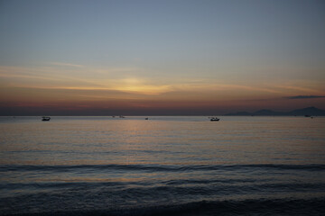 Fototapeta premium Fishing boats at sea with sunrise in the background. Dawning sky before sunrise