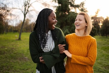 Fototapeta premium Diverse women laughing enjoying friendship bonding in park