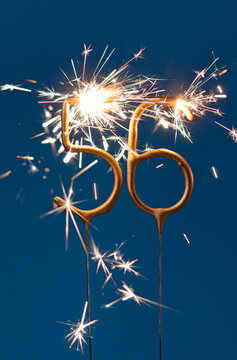 56 years anniversary celebration festive background made with Bengal fires in the form of number Fifty six. Vertical photography.