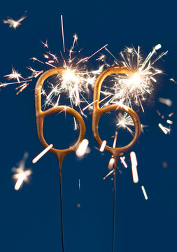66 years anniversary celebration festive background made with Bengal fires in the form of number Sixty six. Vertical photography.