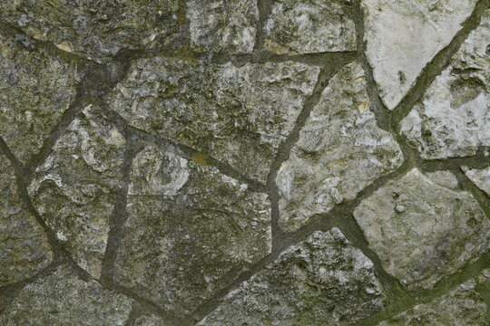 Muted Gray Greenish Irregular Stone Fragment Texture Background Weathered Rough Granular Surface Natural Aged Wall Pattern with Recessed Grout Lines for Copy Space