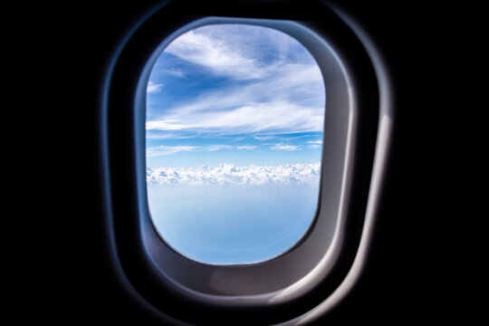 View through a jet plane window high on the blue sky