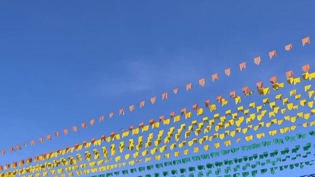 Colorful festival flags against blue sky
