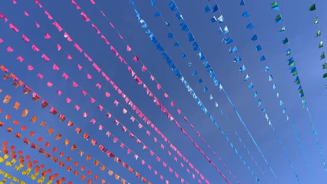 Colorful festival flags under clear sky