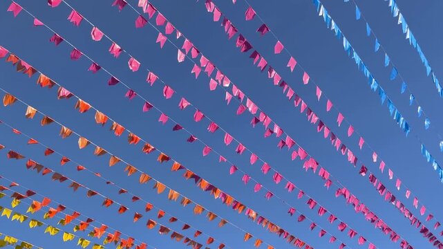 Celebration flags against blue sky