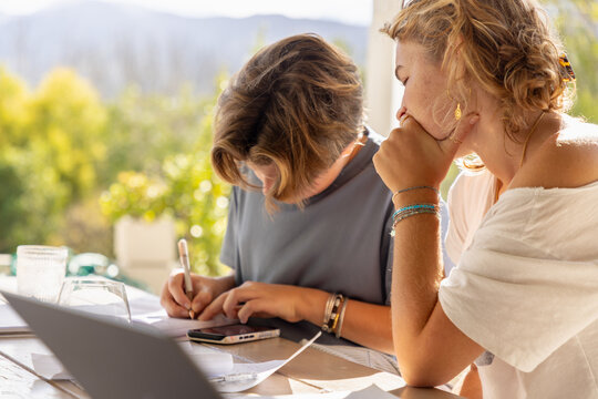 young woman tutoring a student outdoors