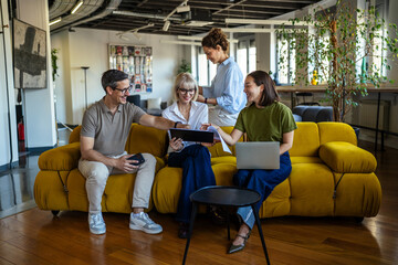 Fototapeta premium Diverse start up team collaborating on project in modern office