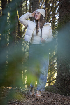 Beautiful woman posing for a photo with the dense forest vegetation of the pacific north west in Oregon.