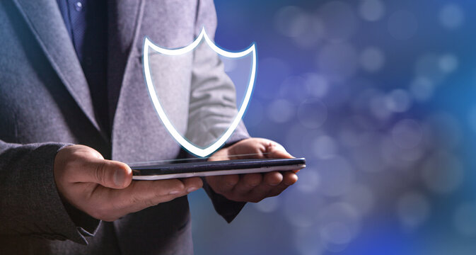 a man taps on a screen with a virtual shield