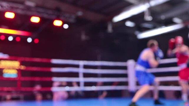 Blurred motion of two boxers exchanging punches in ring during boxing competition