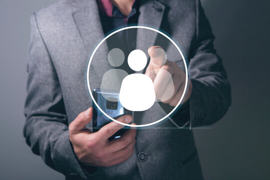 businessman holding a social network icon on a dark background, man and people icon