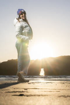 woman posing for a photo shoot on the very popular beach in southern Oregon. Myers Creek beach at sunset.