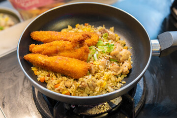 Fototapeta premium Freshly fried food served in a frying pan ready for dining.