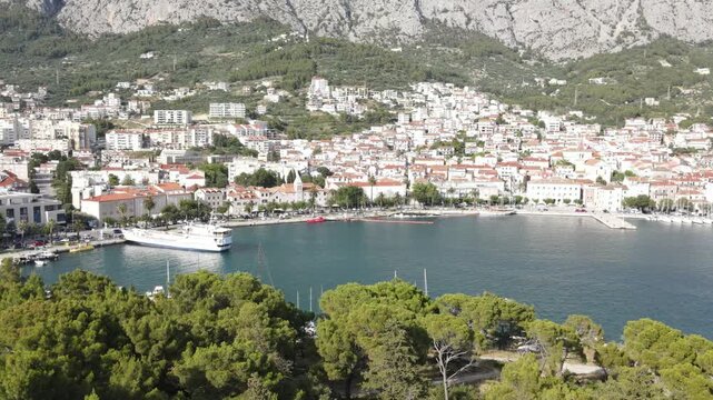 Makarska, Croatia. Coastal town, sea and mountains, Biokovo park. Aerial photography from a drone. Croatian town on the Adriatic Sea. Makarska Riviera