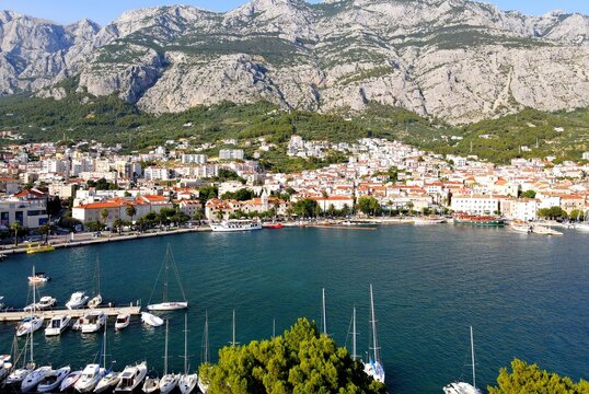Makarska, Croatia. Coastal town, sea and mountains, Biokovo park. Aerial photography from a drone. Croatian town on the Adriatic Sea. Makarska Riviera